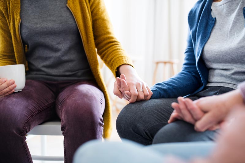 midsection-of-men-and-women-sitting-in-a-circle-du-24MPYUZ.jpg